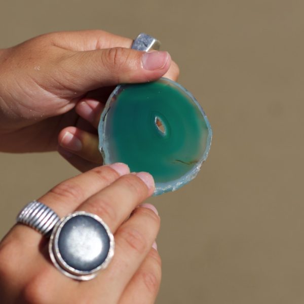 An Agate Crystal slice is embedded into one face of the Pyramid Candle.