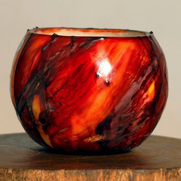 The drama of the Red Planet is reflected in our Mars lantern - dynamic red with black highlights. It is a bold ornament by day, and a dramatic center-point when lit. Photo: Integrity Candles collection.