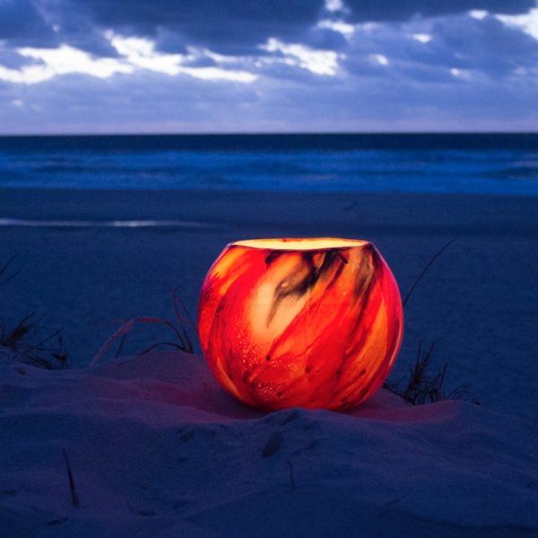 A dramatic Mars Grand Cauldron lantern lights up the beach at twilight. Photo by Frank Gumley