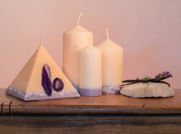 Our Lavender and Vanilla candle nest includes one 90 hour pyramid and three pillar candles (40 hour, 90 hour and 140 hour) a combined burn time over 360 hours. As your pyramid burns, the flame illuminates the Agate crystal, revealing the stone's unique variegated patterns and leaving you with a gorgeous keepsake. The base of all candles are embedded with river pebbles. Deeply relaxing, this intoxicating combination of essential oils make this light cream coloured candle a favourite. The lilac base, is now separated by a warm autumn tone of colour.