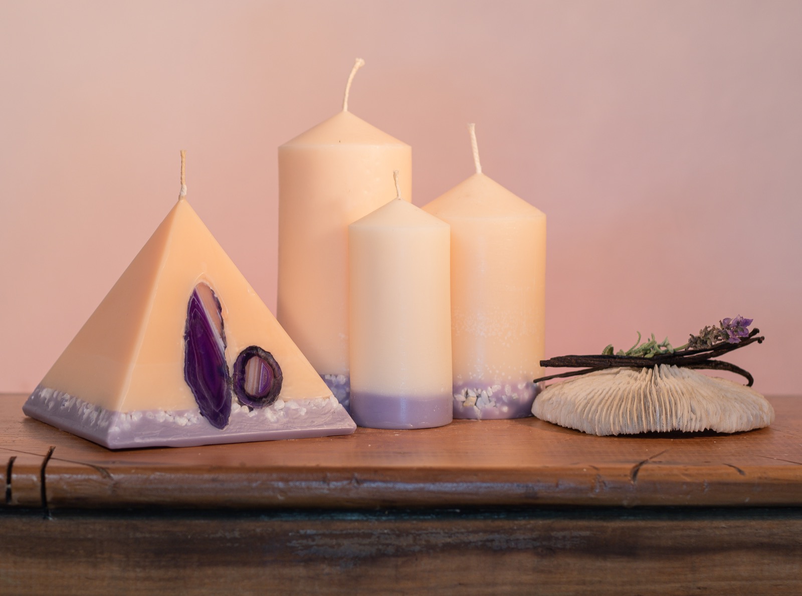Our Lavender and Vanilla candle nest includes one 90 hour pyramid and three pillar candles (40 hour, 90 hour and 140 hour) a combined burn time over 360 hours. As your pyramid burns, the flame illuminates the Agate crystal, revealing the stone's unique variegated patterns and leaving you with a gorgeous keepsake. The base of all candles are embedded with river pebbles. Deeply relaxing, this intoxicating combination of essential oils make this light cream coloured candle a favourite. The lilac base, is now separated by a warm autumn tone of colour.
