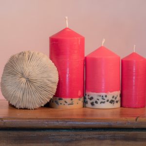 Exotic and mystical, Dragon's Blood has been used across the ages in magic, medicine, art, and as a heady, intoxicating fragrance. The alluring red candle features a white base embedded with small black stone.