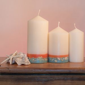 This tropically scented candle range is infused with essential oils of Lime and Coconut. White in colour, these candles feature an orange and blue banded base embedded with sea shells.