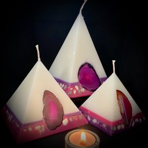 Fresh and elegant, our Rose and Geranium nest of pyramids combined burn time is over 440 hours. As your pyramid candles burn, the flame illuminates the Agate, revealing the stone's unique variegated patterns, and leaves you with gorgeous keepsakes. Visually beautiful, these white bodied pyramids are banded at the base in purple and magenta and embedded with agate and river pebble. Our candles illuminate brightly and boast an exceptionally long burn tim