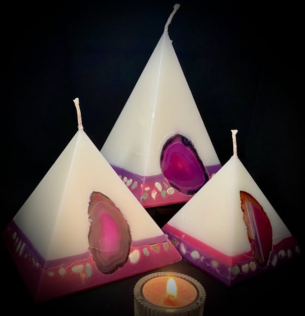 Fresh and elegant, our Rose and Geranium nest of pyramids combined burn time is over 440 hours. As your pyramid candles burn, the flame illuminates the Agate, revealing the stone's unique variegated patterns, and leaves you with gorgeous keepsakes. Visually beautiful, these white bodied pyramids are banded at the base in purple and magenta and embedded with agate and river pebble. Our candles illuminate brightly and boast an exceptionally long burn tim