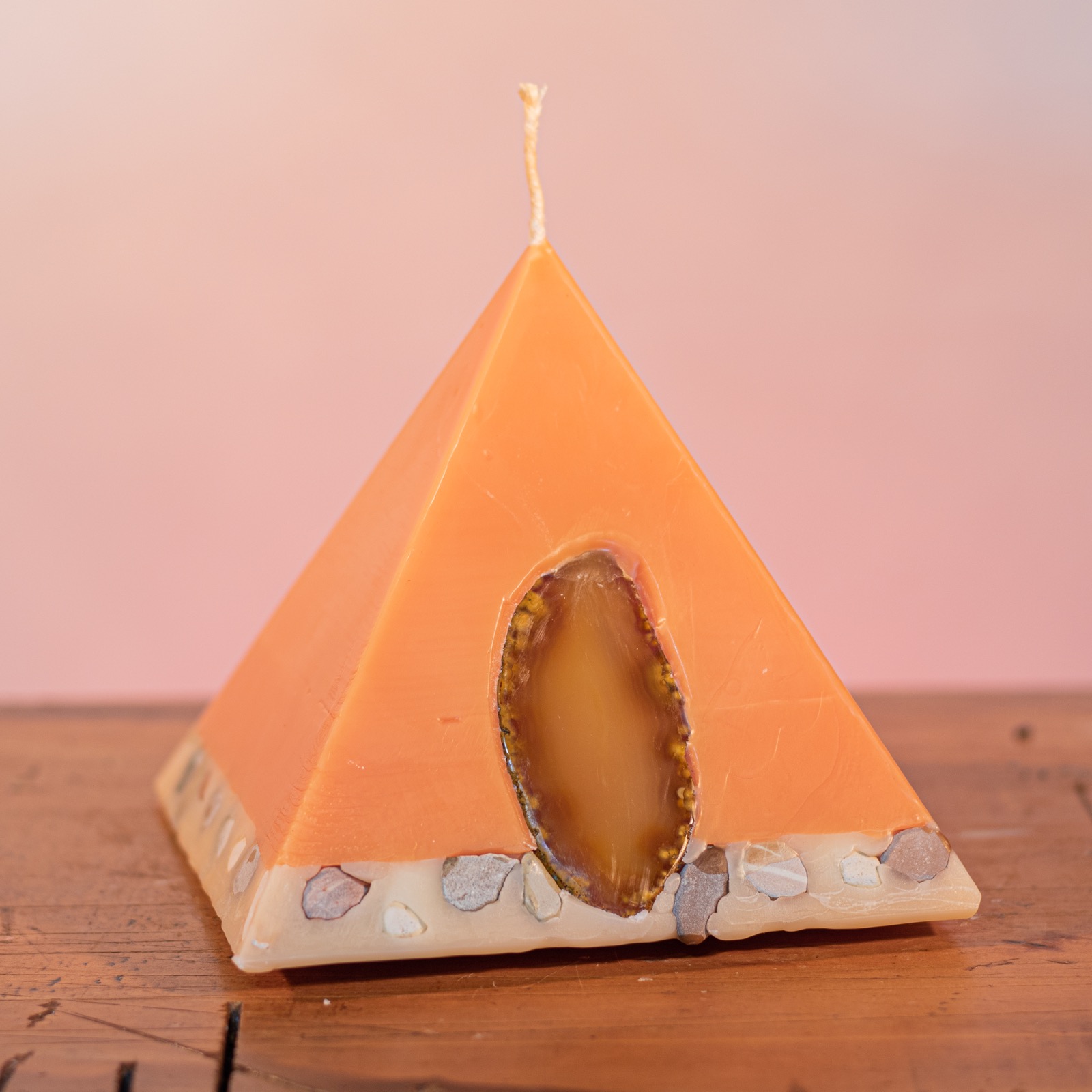 As your pyramid candle burns, the flame illuminates the Agate, revealing the stone's unique variegated patterns and leaves you with a gorgeous keepsake. Infused with essential oils of sweet orange, ginger, cinnamon and vanilla, the appetising apricot coloured candle features a white base embedded with river pebbles. As your pyramid candle burns, the flame illuminates the Agate, revealing the stone's unique variegated patterns and leaves you with a gorgeous keepsake. Infused with essential oils of sweet orange, ginger, cinnamon and vanilla, the appetising apricot coloured candle features a white base embedded with river pebbles.
