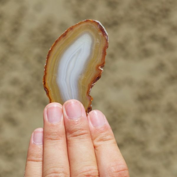 An Agate Crystal slice is embedded into one face of the Pyramid Candle.