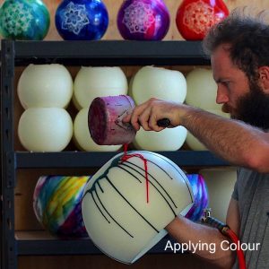 Applying pigments to the lantern prior to blending the colours by torch. Photo: Integrity Candles